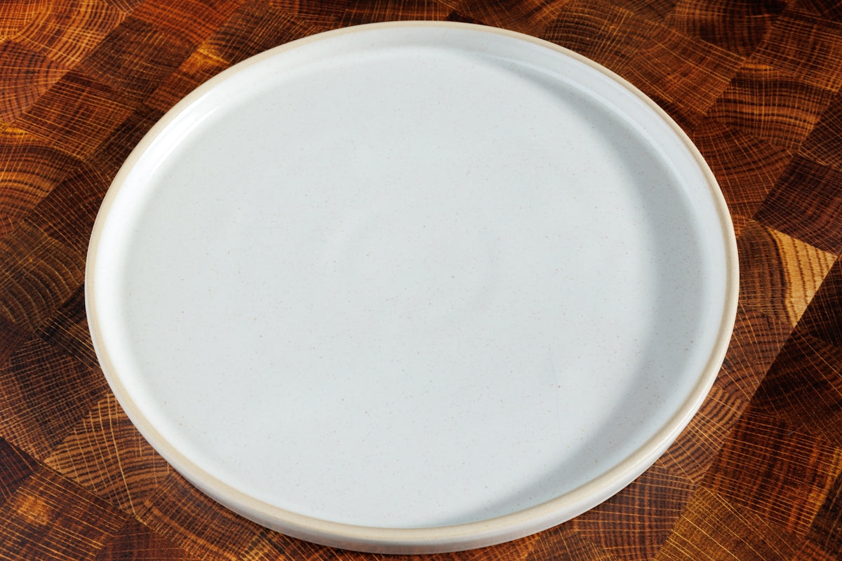 a white plate sitting on top of a wooden table