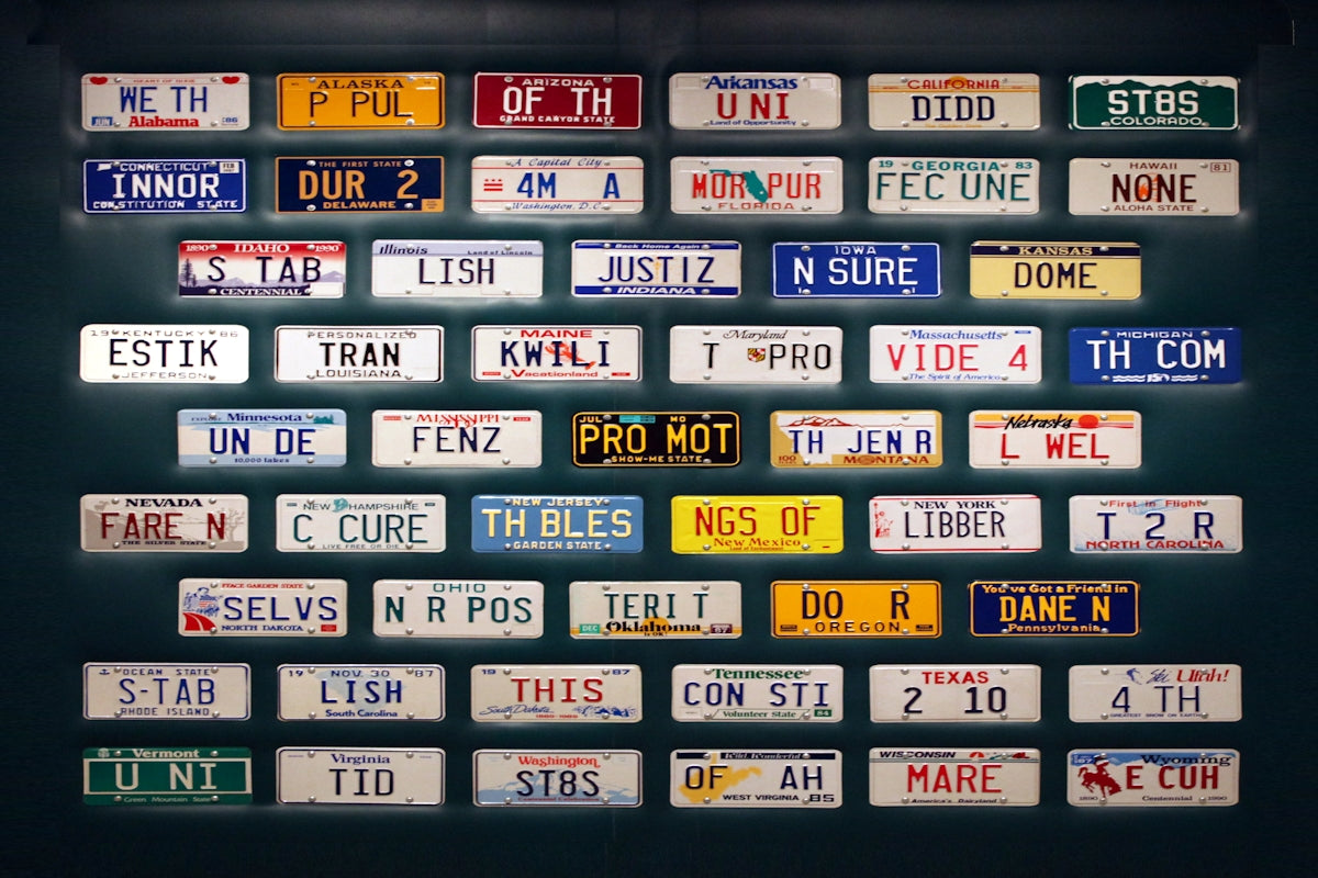 A large number of license plates on a wall