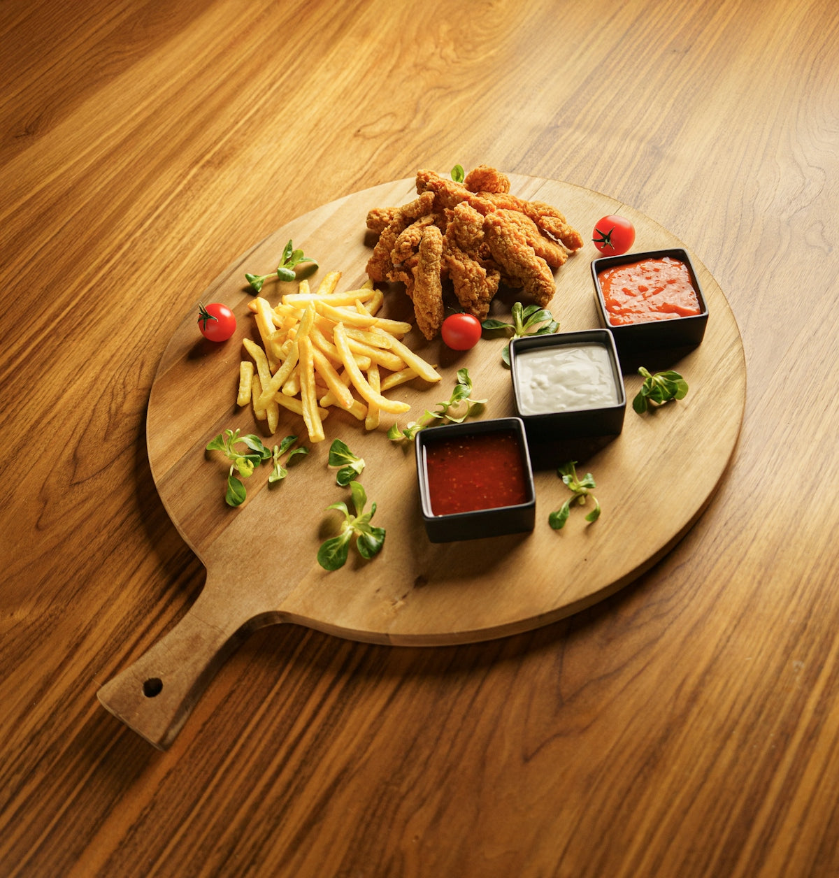 A wooden plate topped with french fries and ketchup