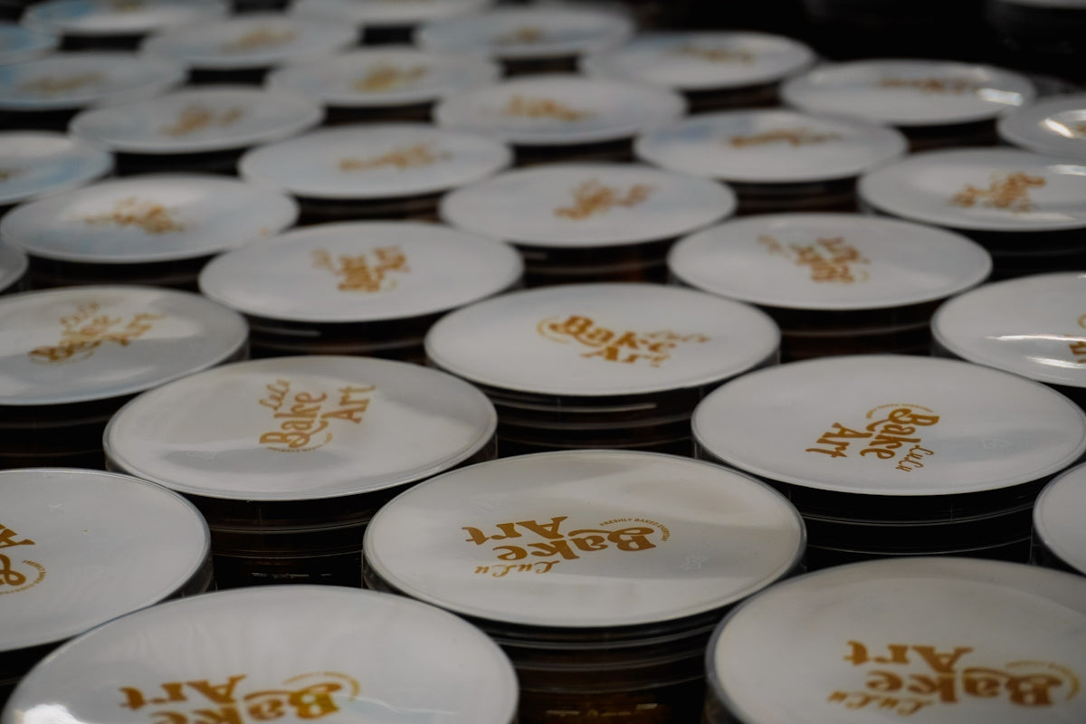 Rows of white plates with golden lettering