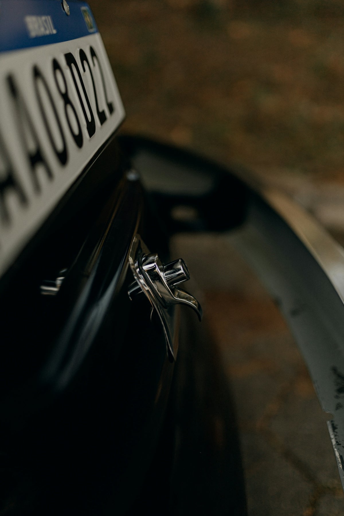 Close-up of a car's license plate and bumper