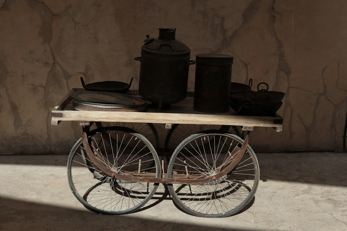 Antique cart with cooking pots and utensils