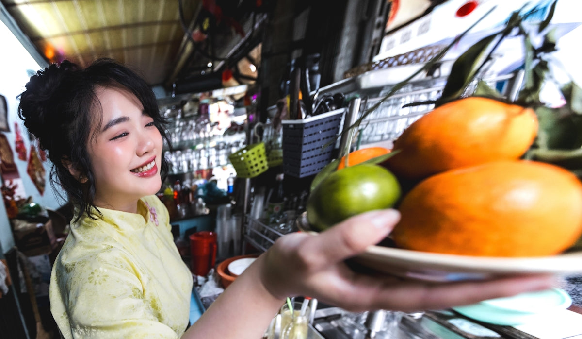 Woman holding a plate of fruit