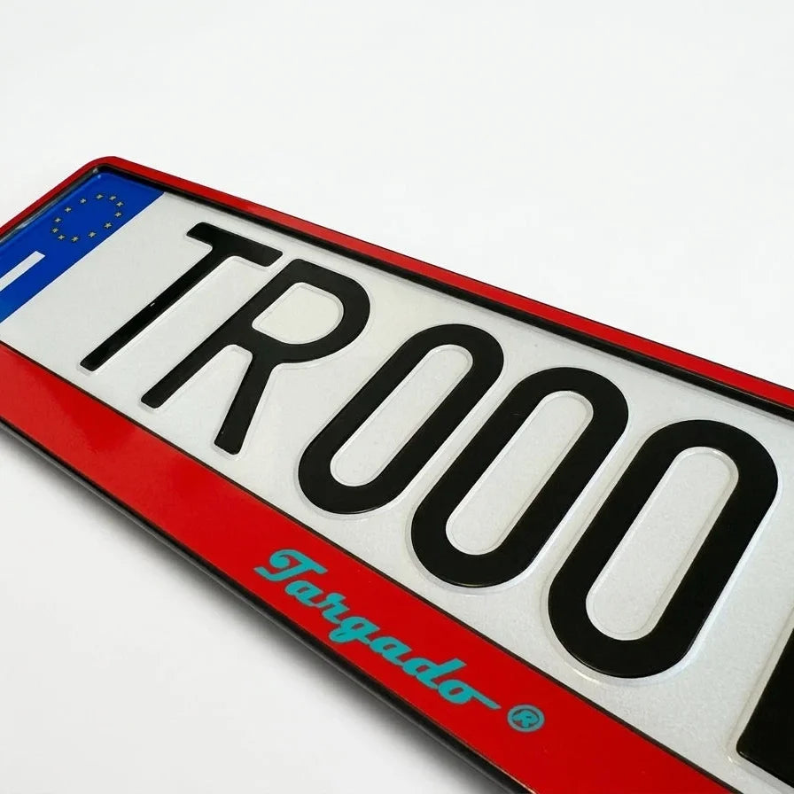 Red Targado Srl license plate holder with 'TR000' text and EU strip