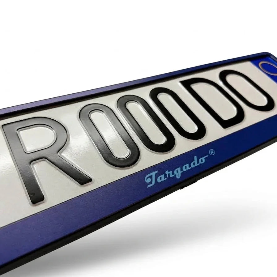 Close-up of a blue Targado Srl license plate holder with black embossed characters.
