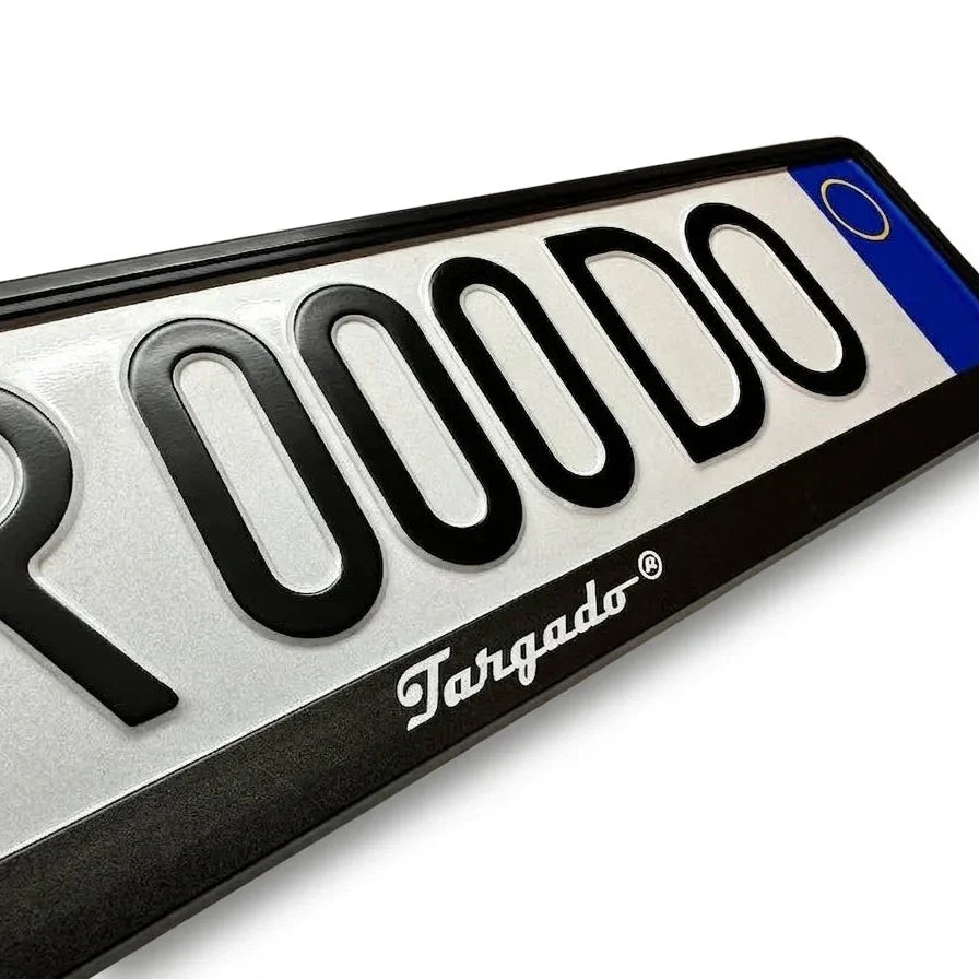 Close-up of the Targado Srl Model Mamba white license plate holder with embossed black letters.