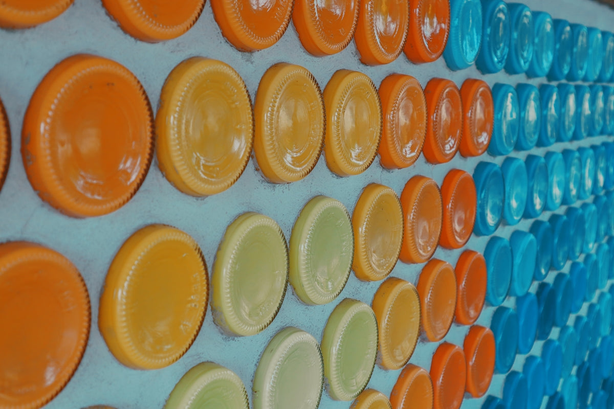 a wall of orange, yellow, and blue plates