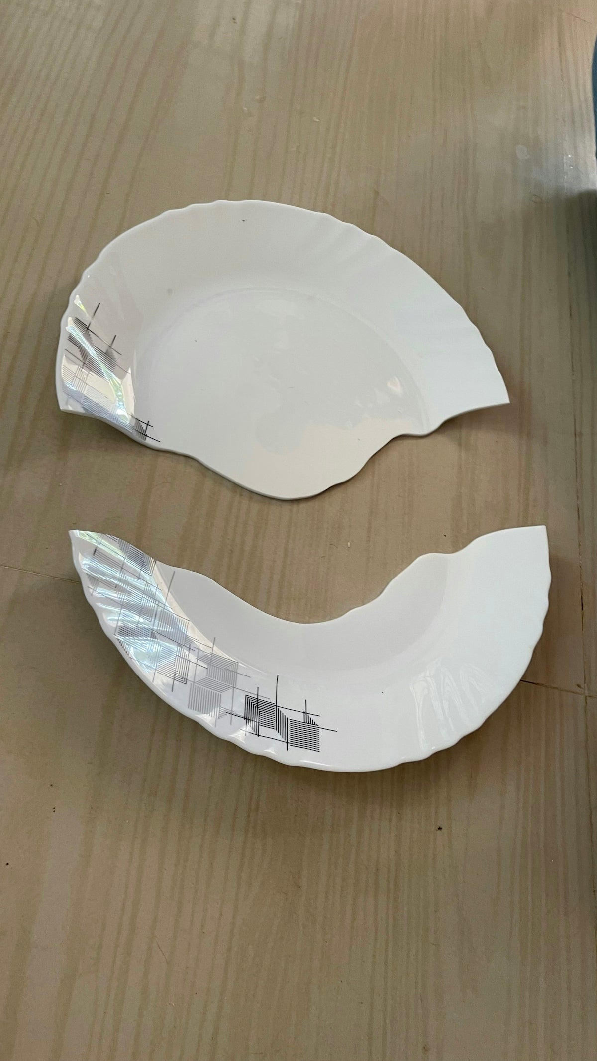 a couple of white plates sitting on top of a wooden table