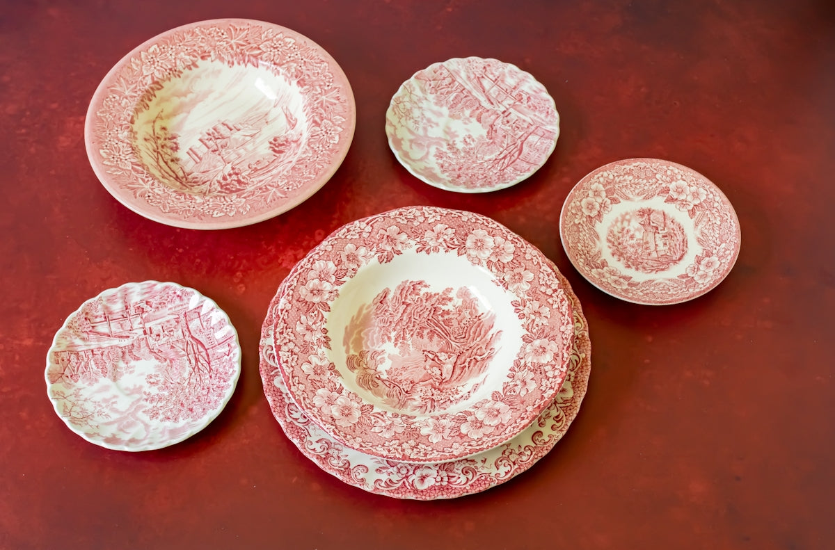 a group of red and white plates sitting on top of a table