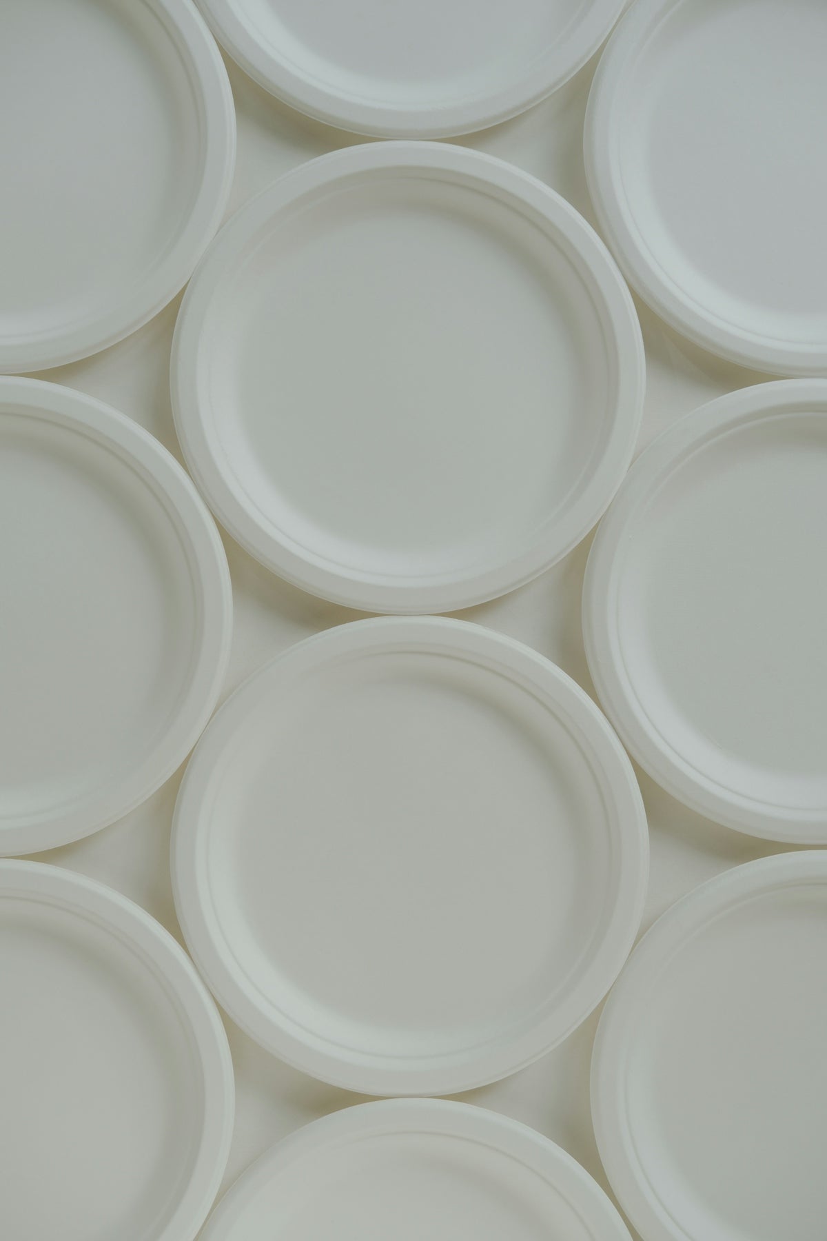 A group of white plates sitting on top of each other