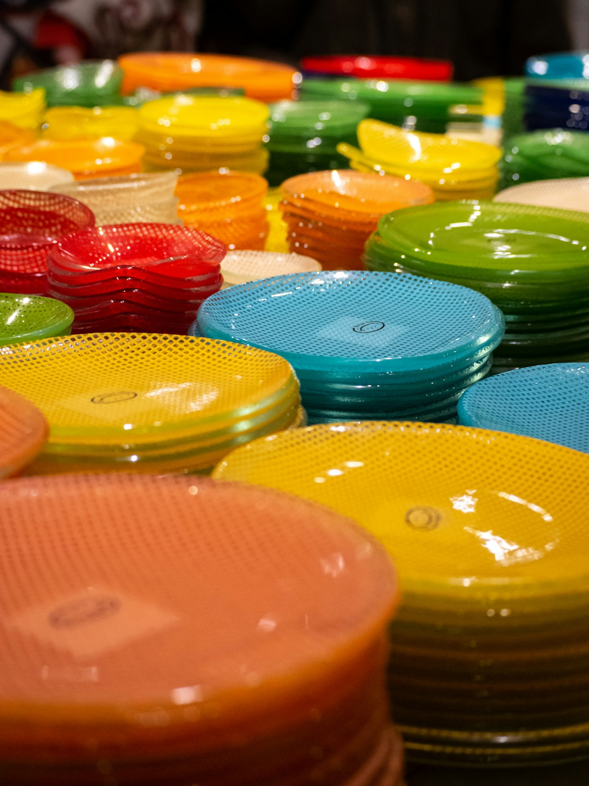 A table topped with lots of colorful plates