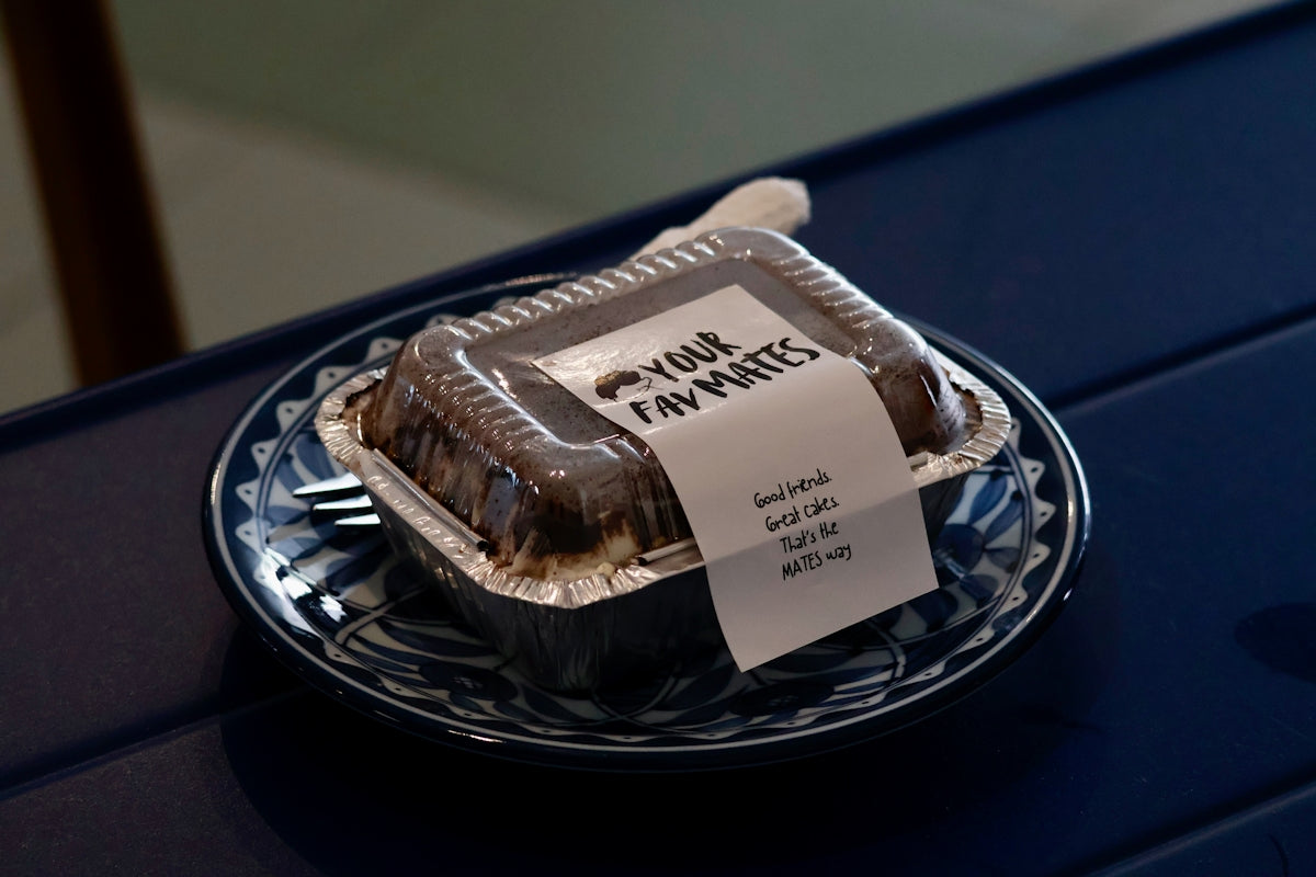 A chocolate cake in a clear plastic container.
